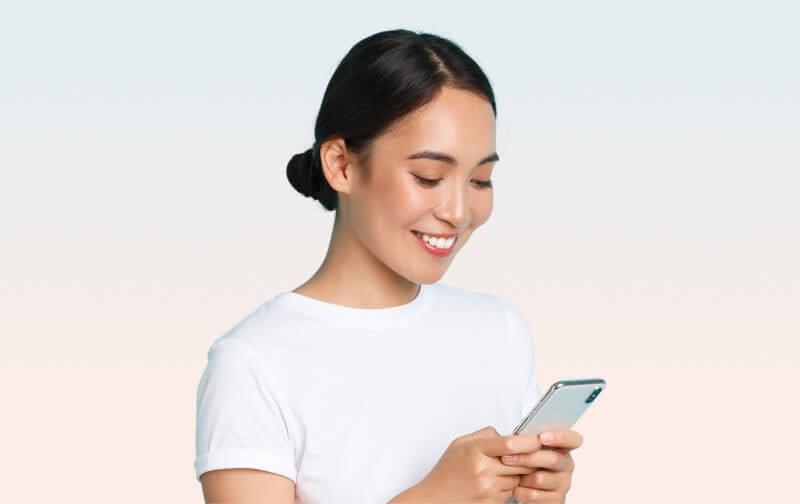 Smiling woman texting